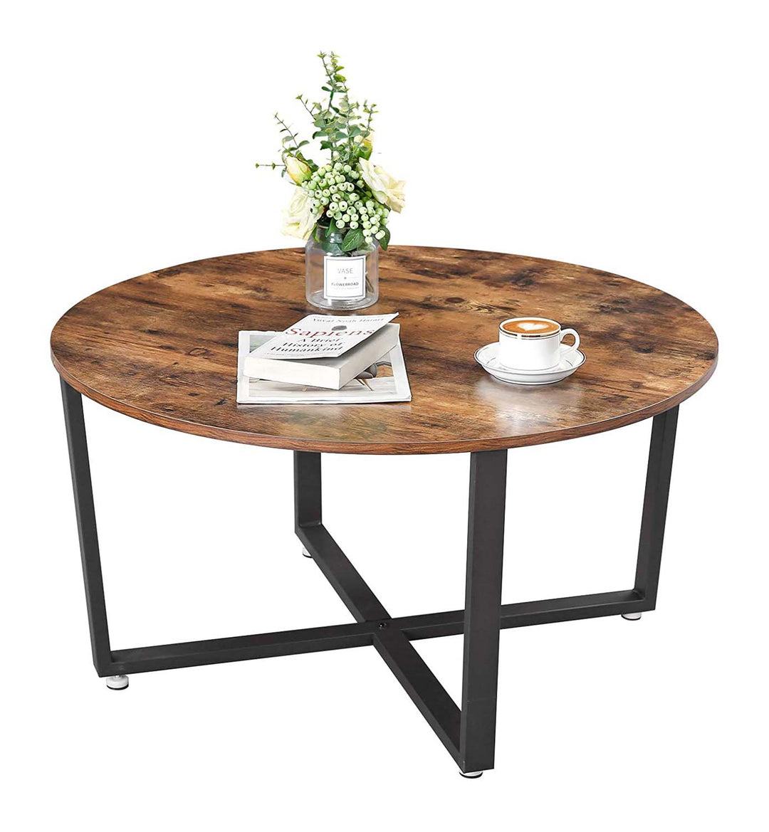Rundt sofabord med kaffe, bog og plante